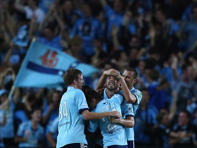 Sydney's Matthew Jurman celebrates with teammates after scoring his team's first goal against Western Sydney during their A-League match on March 8, 2014