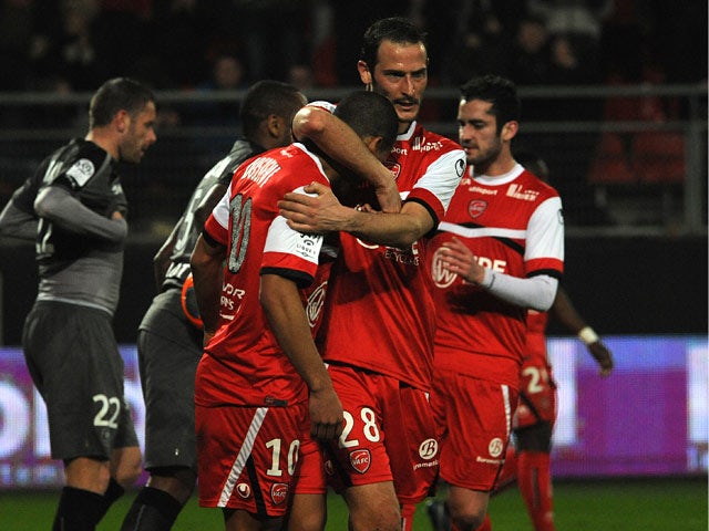 Valenciennes's Matthieu Dossevi celebrates with teammates after scoring his team's first goal against Rennes during their Ligue 1 match on March 8, 2014