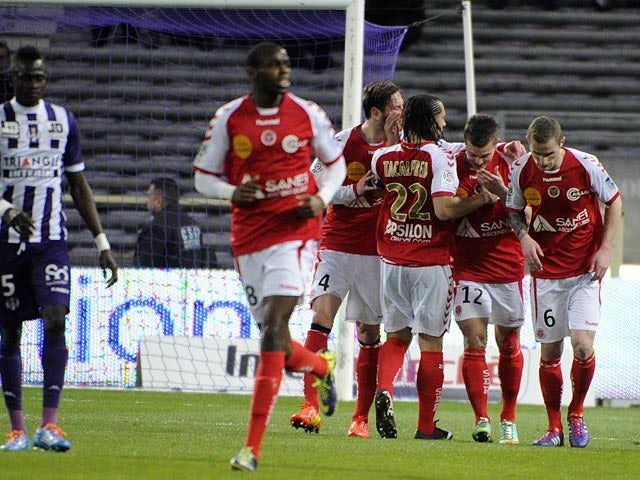 Reims' Nicolas De Preville celebrates with teammates after scoring his team's second goal against Toulouse during their Ligue 1 match on March 8, 2014