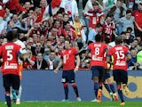 Lille's Nolan Roux celebrates with teammates in front of fans after scoring his team's second goal against Montpellier during their Ligue 1 match on March 9, 2014
