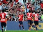 Lille's Nolan Roux celebrates with teammates in front of fans after scoring his team's second goal against Montpellier during their Ligue 1 match on March 9, 2014
