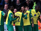 Bradley Johnson of Norwich is congratulated by teammates after scoring the opening goal during the Barclays Premier League match between Norwich and Stoke at Carrow Road on March 8, 2014