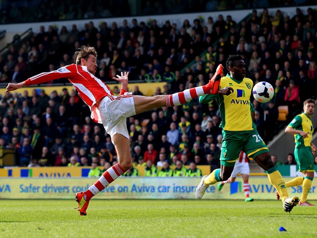 Peter Crouch of Stoke stretches in vain to reach a cross during the Barclays Premier League match between Norwich and Stoke at Carrow Road on March 8, 2014