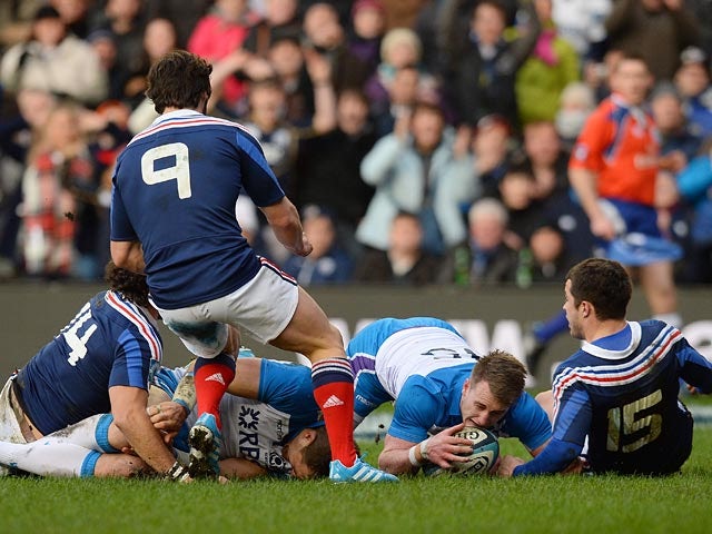 Scotland's Stuart Hogg scores the first try against France during their Six Nations International rugby union match on March 8, 2014