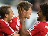 Bayern Munich's Thomas Muller celebrates with teammates after scoring the equaliser against Wolfsburg during their Bundesliga match on March 8, 2014