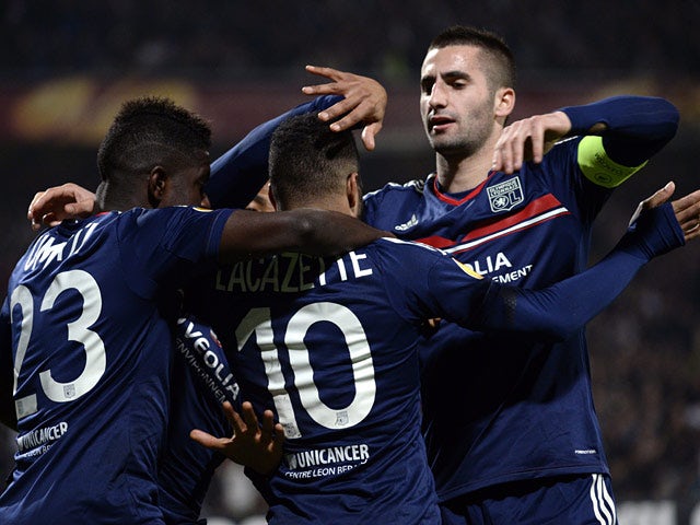 Lyon's Alexandre Lacazette is congratulated by teammates after scoring against Viktoria Plzen during their Europa League match on March 13, 2014