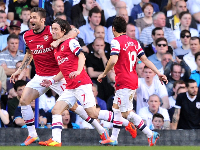 Arsenal's Czech midfielder Tomas Rosicky celebrates after scoring his team's first goal during the English Premier League football match between Tottenham Hotspur and Arsenal at White Hart Lane in north London on March 16, 2014