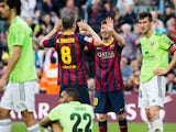 Lionel Messi of FC Barcelona is congratulated by his teammate Andres Iniesta after scoring his team's fourth goal and his goal number 370 for the FC Barcelona becoming the maximum scorer on the history of FC Barcelona during the La Liga match between FC B