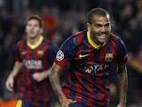 Barcelona's Brazilian defender Dani Alves celebrates after scoring during the UEFA Champions League round of 16 second leg football match FC Barcelona vs Manchester City at the Camp Nou stadium in Barcelona on March 12, 2014
