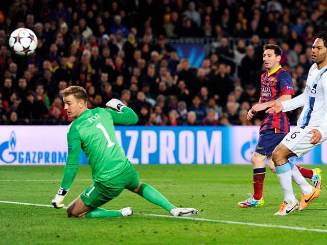 Lionel Messi of Barcelona flicks the ball past goalkeeper Joe Hart of Manchester City to score the opening goal during the UEFA Champions League Round of 16, second leg match between FC Barcelona and Manchester City at Camp Nou on March 12, 2014