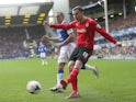 Jordan Mutch of Cardiff City shoots away from Leon Osman of Everton during the Barclays Premier League match between Everton and Cardiff City at Goodison Park on March 15, 2014