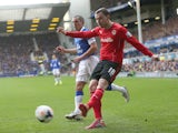 Jordan Mutch of Cardiff City shoots away from Leon Osman of Everton during the Barclays Premier League match between Everton and Cardiff City at Goodison Park on March 15, 2014
