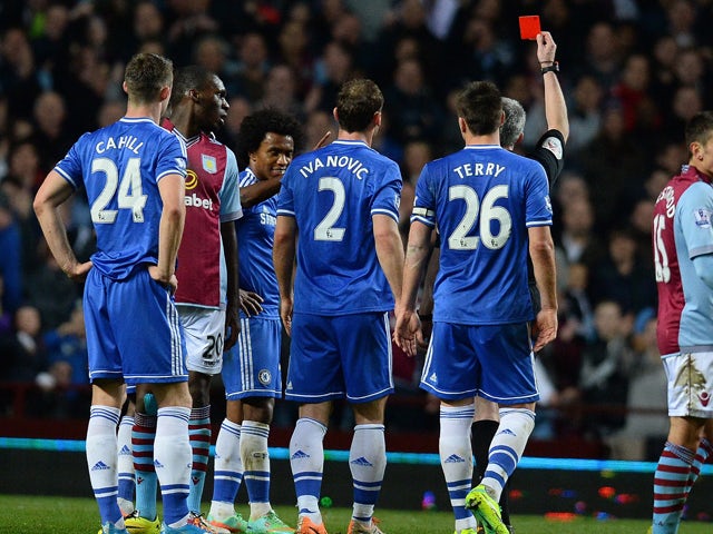 Chelsea's Brazilian midfielder Willian is shown a red card by referee Chris Foy during the English Premier League football match between Aston Villa and Chelsea at Villa Park in Birmingham on March 15, 2014