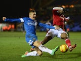 Dany N'Gussan of Swindon Town battles with Danny Kearns of Peterborough United during the Johnstone's Paint Southern Area Final between Peterborough United and Swindon Town at London Road on February 5, 2014