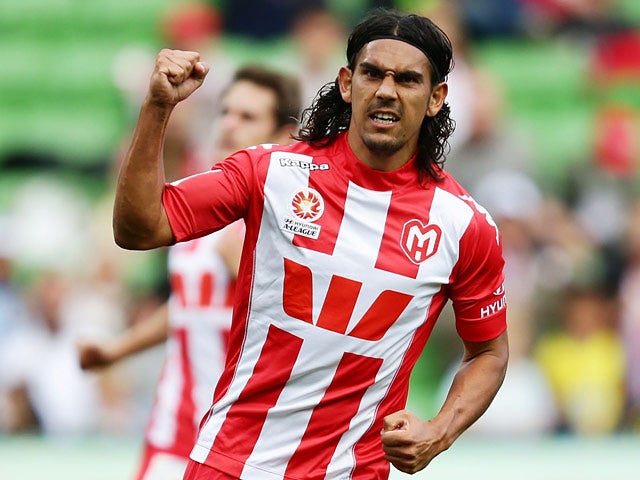 Melbourne Heart's David Williams celebrates after scoring his team's third goal against Wellington Phoenix during the A-League match on March 16, 2014