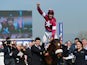 Davy Russell on Tiger Roll celebrates winning the JCB Triumph Hurdle during the Cheltenham Festival at Cheltenham Racecourse on March 14, 2014