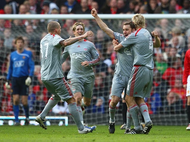 Liverpool's Fabio Aurelio celebrates with teammates after scoring his team's third goal against Manchester United during their Premier League match on March 14, 2009