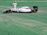 Massa of Brazil and Williams and Kamui Kobayashi of Japan and Caterham come together and spin out into the gravel at turn one at the start of the Australian Formula One Grand Prix at Albert Park on March 16, 2014