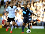 Yoan Gouffran of Newcastle controls the ball as Lewis Holtby of Fulham closes in during the Barclays Premier league match between Fulham and Newcastle United at Craven Cottage on March 15, 2014