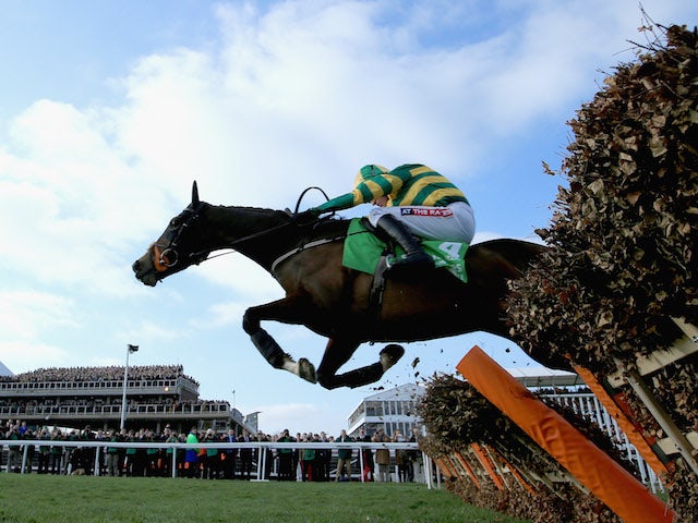 Barry Geraghty on Jezki jumps the last on his way to victory in The Stan James Champion Hurdle Challenge Trophy during The Festival Champion Day at Cheltenham Racecourse on March 11, 2014