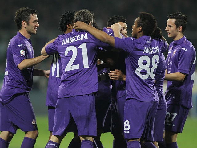 Fiorentina's Juan Cuadrado is congratulated by teammates after scoring the opening goal against Chievo Verona during the Serie A match on March 16, 2014