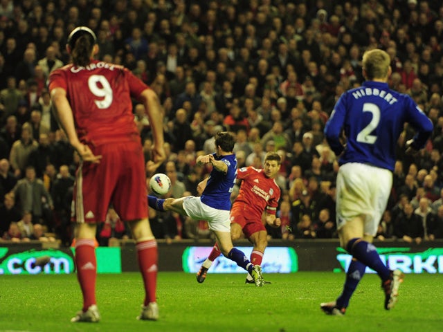 Steven Gerrard of Liverpool scores the opening goal during the Barclays Premier League match between Liverpool and Everton at Anfield on March 13, 2012