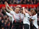 Steven Gerrard of Liverpool celebrates scoring the first goal with his team-mates during the Barclays Premier League match between Manchester United and Liverpool at Old Trafford on March 16, 2014