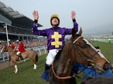 Davy Russell celebrates after riding Lord Windermere to victory in the Betfred Cheltenham Gold Cup Chase on Gold Cup day at the Cheltenham Festival at Cheltenham Racecourse on March 14, 2014