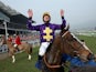 Davy Russell celebrates after riding Lord Windermere to victory in the Betfred Cheltenham Gold Cup Chase on Gold Cup day at the Cheltenham Festival at Cheltenham Racecourse on March 14, 2014