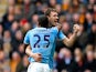 Edin Dzeko of Manchester City celerates with teammate Fernandinho after scoring his team's second goal during the Barclays Premier league match between Hull City and Manchester City at KC Stadium on March 15, 2014
