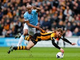 Nikica Jelavic of Hull City is brought down by Vincent Kompany of Manchester City during the Barclays Premier league match between Hull City and Manchester City at KC Stadium on March 15, 2014
