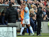 Vincent Kompany of Manchester City gestures with his hand as he leaves the field after being shown a red card during the Barclays Premier League match between Hull City and Manchester City at the KC Stadium on March 15, 2014