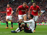 Nemanja Vidic of Manchester United and Rafael react to Daniel Sturridge of Liverpool after the award of the second penalty kick during the Barclays Premier League match between Manchester United and Liverpool at Old Trafford on March 16, 2014