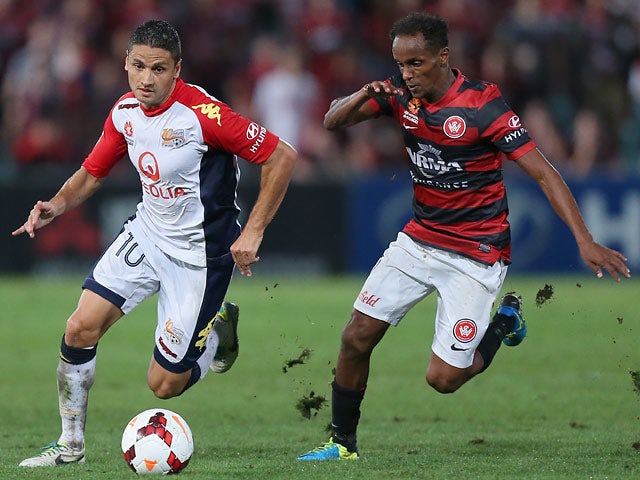 Adelaide's Marcelo Carrusca and Western Sydney's Youssouf Hersi in action during the A-League match on March 15, 2014