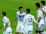 Melbourne's Mark Milligan celebrates with teammates after scoring his team's first goal against Perth Glory during the A-League match on March 15, 2014