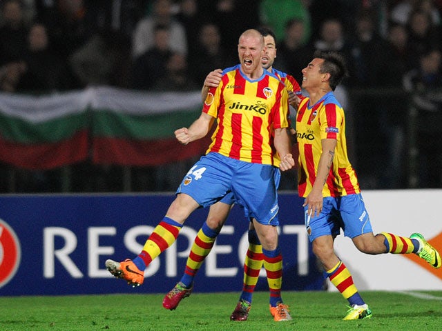 Valencia's Philippe Senderos celebrates with teammates after scoring his team's third goal against Ludogorets during their Europa League match on March 13, 2014