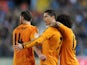 Cristiano Ronaldo of Real Madrid celebrates with Xabi Alonso and Marcelo after scoring Real's opening goal during the La Liga match between Malaga and Real Madrid at La Rosaleda Stadium on March 15, 2014