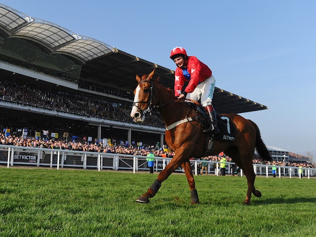 Jamie Moore and Sire de Grugy celebrate victory in the BetVictor Queen Mother Champion Chase during Ladies Day at Cheltenham Festival at Cheltenham Racecourse on March 12, 2014