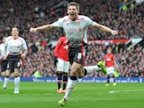 Steven Gerrard celebrates scoring his and Liverpool's second goal against Manchester United in the Premier League at Old Trafford on March 16, 2014
