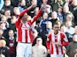 Peter Crouch and Peter Odemwingie of Stoke City celebrate as Crouch's shot deflects into the goal off of Odemwingie for their first goal during the Barclays Premier League match between Stoke City and West Ham United at Britannia Stadium on March 15, 2014