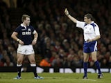 Referee Jerome Garces shows a yellow card to Scotland's Stuart Hogg after a late tackle on Wales' Dan Biggar, the yellow card was soon after changed to a red card during the Six Nations international rugby union match between Wales and Scotland at the Mil