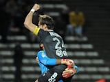 Valenciennes' Brazilian goalkeeper Novaes Magno and Valenciennes' Uruguayan defender Gary Kagelmacher celebrate following the French L1 football match Evian-Thonon (ETGFC) vs Valenciennes (VAFC) at the Parc des Sports in Annecy, central eastern France, on