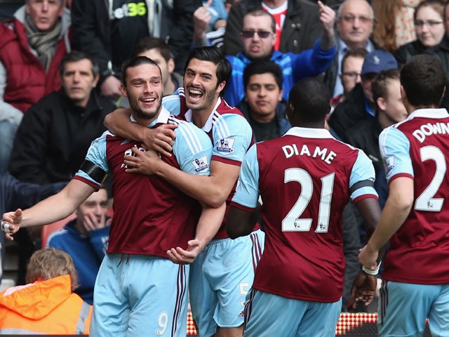 Andy Carroll of West Ham United celebrates with team mates as he scores their first goal during the Barclays Premier League match between Stoke City and West Ham United at Britannia Stadium on March 15, 2014