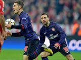 Arsenal midfielder Aaron Ramsey celebrates with teammate Santi Cazorla during the Champions League game against Bayern Munich on March 13, 2013