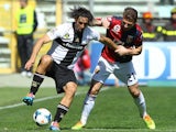 Amauri Carvalho De Oliveira of Parma FC competes for the ball with Marco Motta of Genoa CFC during the Serie A match on March 23, 2014
