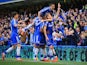 Andre Schurrle of Chelsea celebrates scoring with teammates against Arsenal on March 22, 2014
