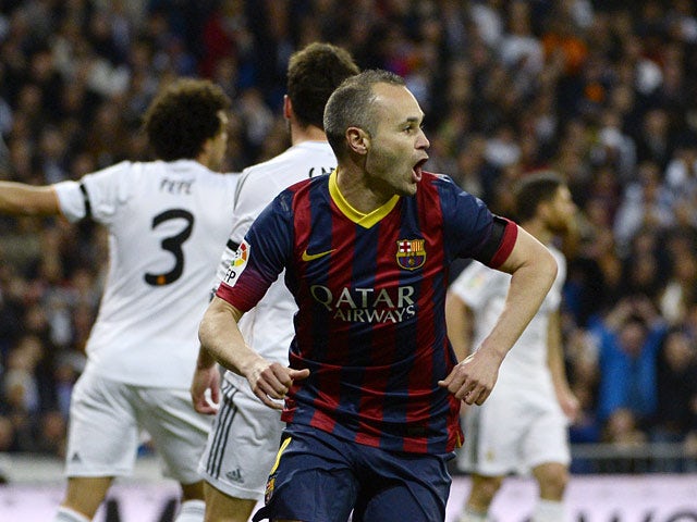 Barcelona's Andres Iniesta celebrates after scoring the opening goal against Real Madrid in the La Liga match on March 23, 2014