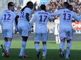 Lyon's Bafetimbi Gomis celebrates with teammates after scoring the opening goal against Guingamp in the Ligue 1 match on March 23, 2014