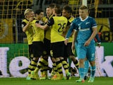 Dortmund´s players celebrate after scoring during the last 16 second-leg UEFA Champions League football match Borussia Dortmund vs Zenit St Petersburg in Dortmund, western Germany on March 19, 2014