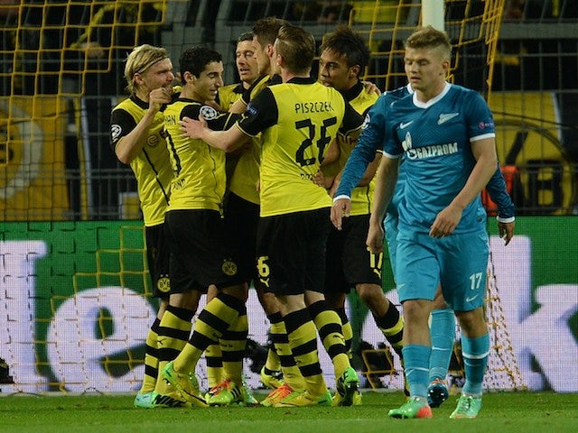 Dortmund´s players celebrate after scoring during the last 16 second-leg UEFA Champions League football match Borussia Dortmund vs Zenit St Petersburg in Dortmund, western Germany on March 19, 2014